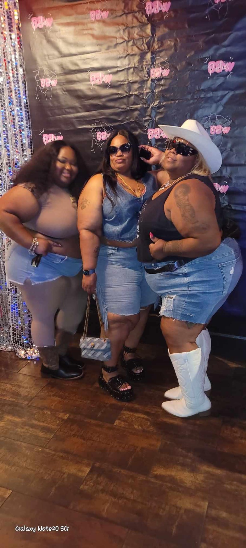 Three BBW Parties guests at the branded step-and-repeat backdrop