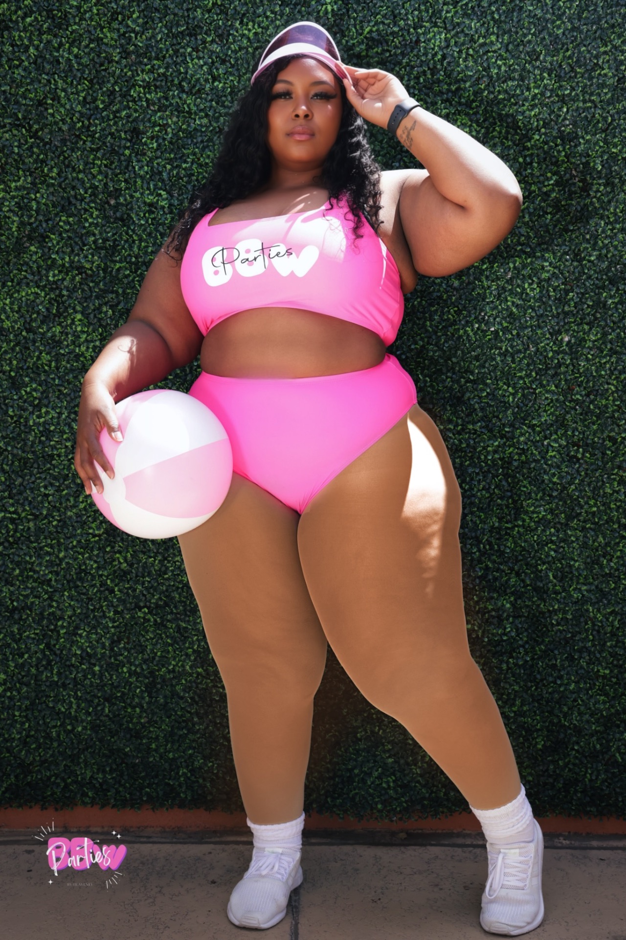 Pretty Girl Society member in bright pink swimwear during a summer brand shoot